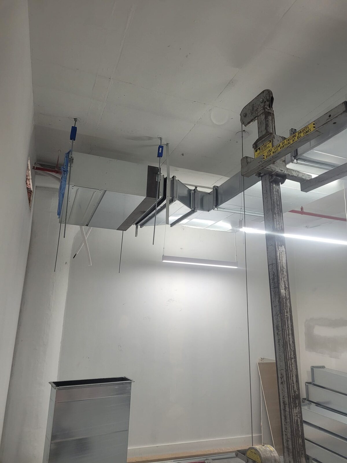 Suspended rectangular ductwork installation in progress