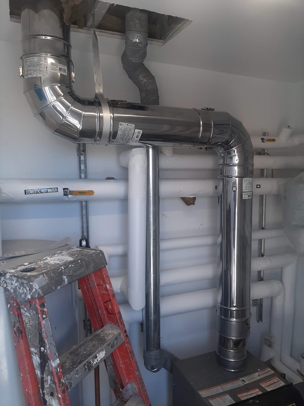 Complete polished flue assembly in a mechanical room